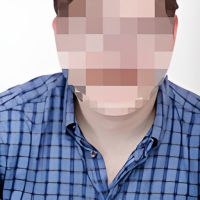 A stock photo of a person with his face blurred out.